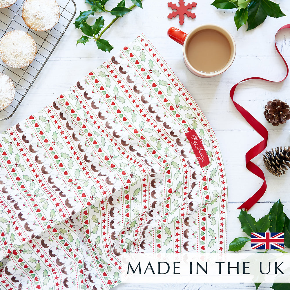 Christmas tea towel with Christmas puddings, holly and hearts