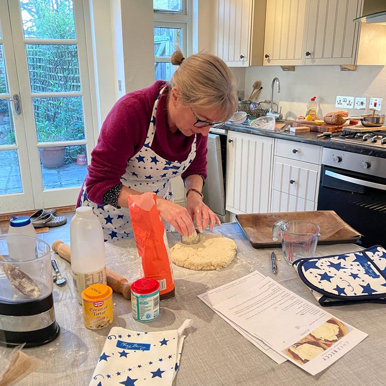 Cook Beccy cutting out scones in her kitchen