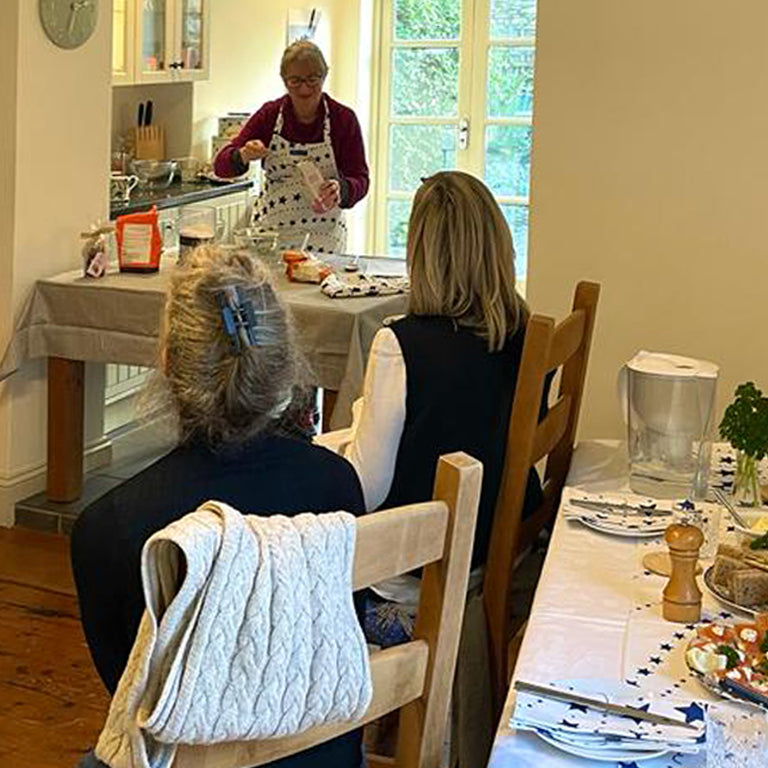 Cook Beccy baking scones with 2 people watching