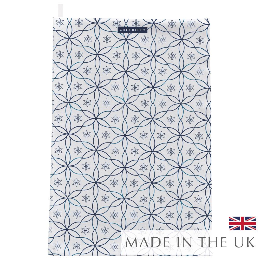A beautifully designed Navy Daisy Tea Towel featuring an elegant geometric floral pattern in deep navy blue. Made from 100% half panama cotton, this absorbent and stylish kitchen towel is perfect for drying dishes and adding a decorative touch to any home. Designed and made in the UK.