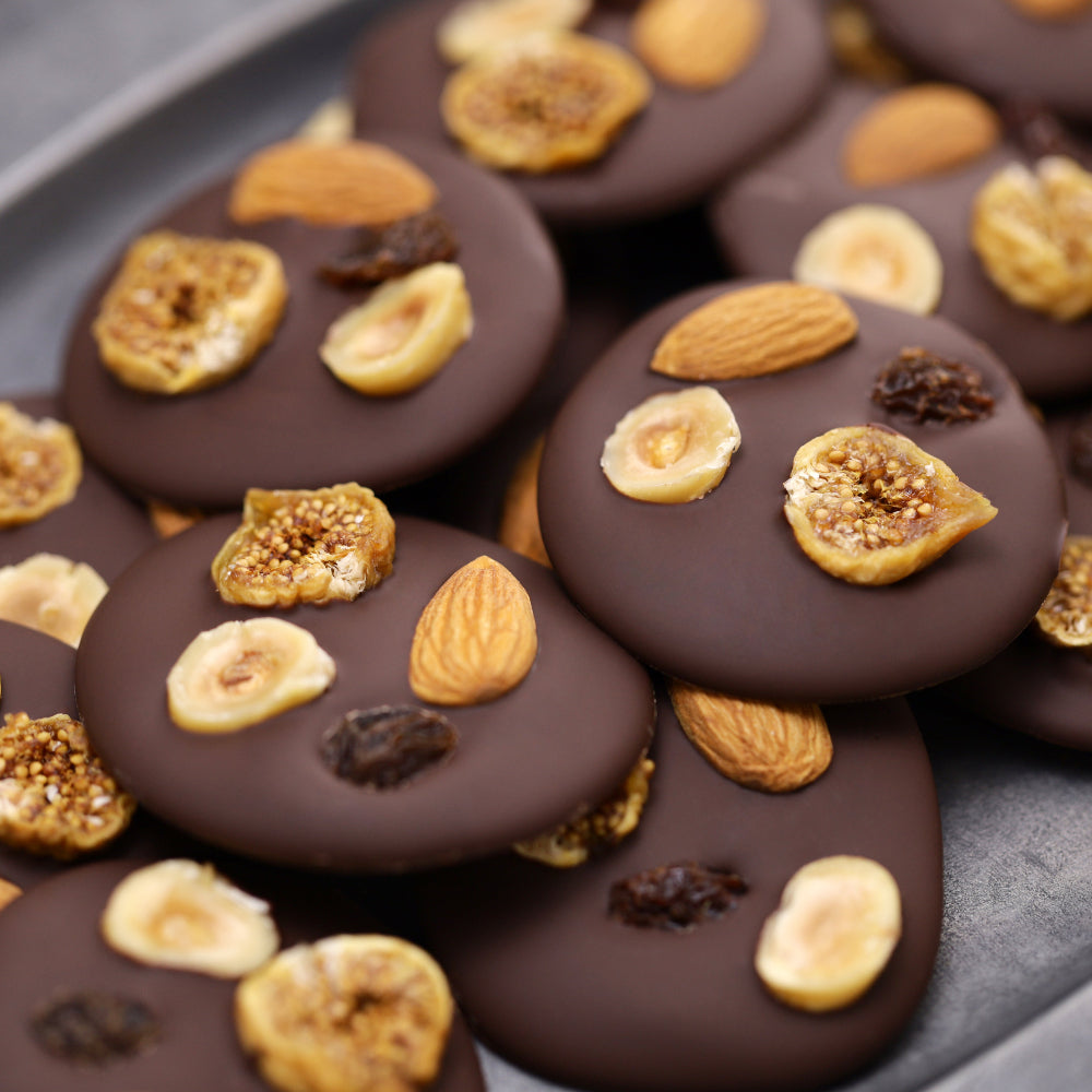 Handmade chocolate mendiants with dried fruit and nuts made during a Chocolate Truffle Workshop in Oxfordshire.