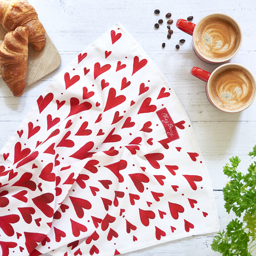 red hearts tea towel with a croissant and 2 mugs of coffee