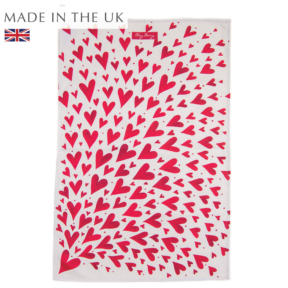 Red Shooting Hearts Tea Towel featuring a hand-painted design of red hearts on 100% half panama cotton fabric, measuring approximately 70 cm by 47 cm. Designed and made in the UK.