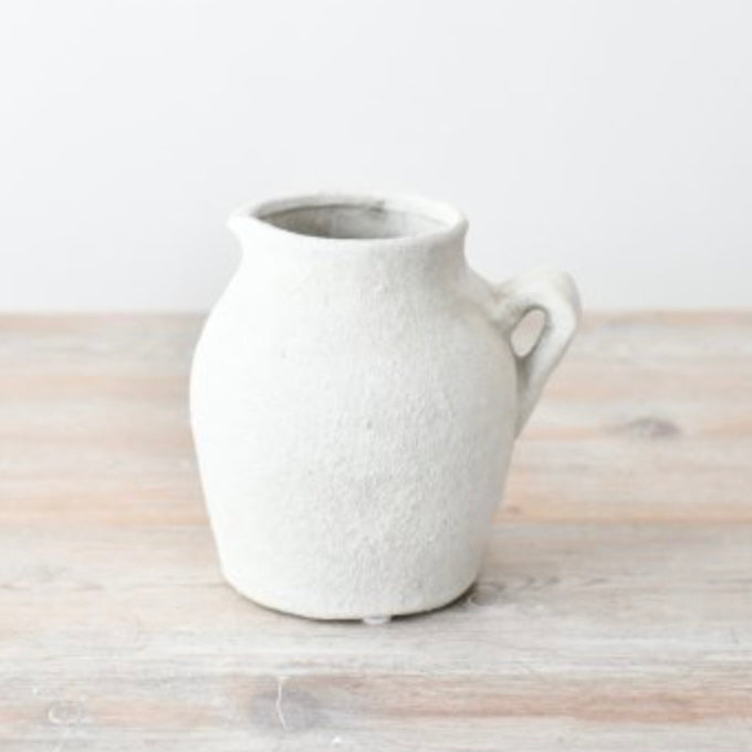 Rustic white Cotswold-style ceramic jug with a textured finish and curved handle. Perfect for displaying fresh flowers, serving drinks, or adding farmhouse charm to any home. A timeless decorative piece for vintage and country-style interiors.