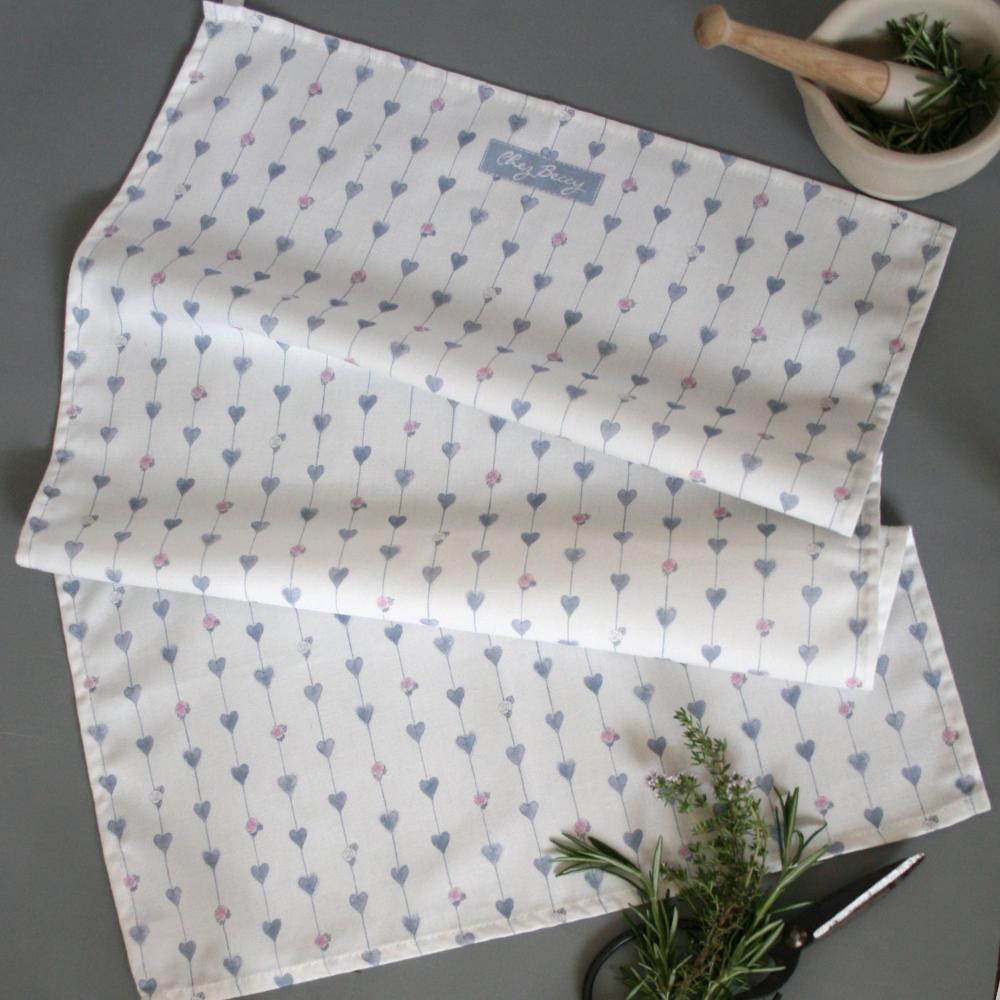 Grey Hearts & Roses Tea Towel – A 100% cotton kitchen towel featuring a delicate botanical hearts and roses design in soft grey, with an ivory hanging loop for convenience.
