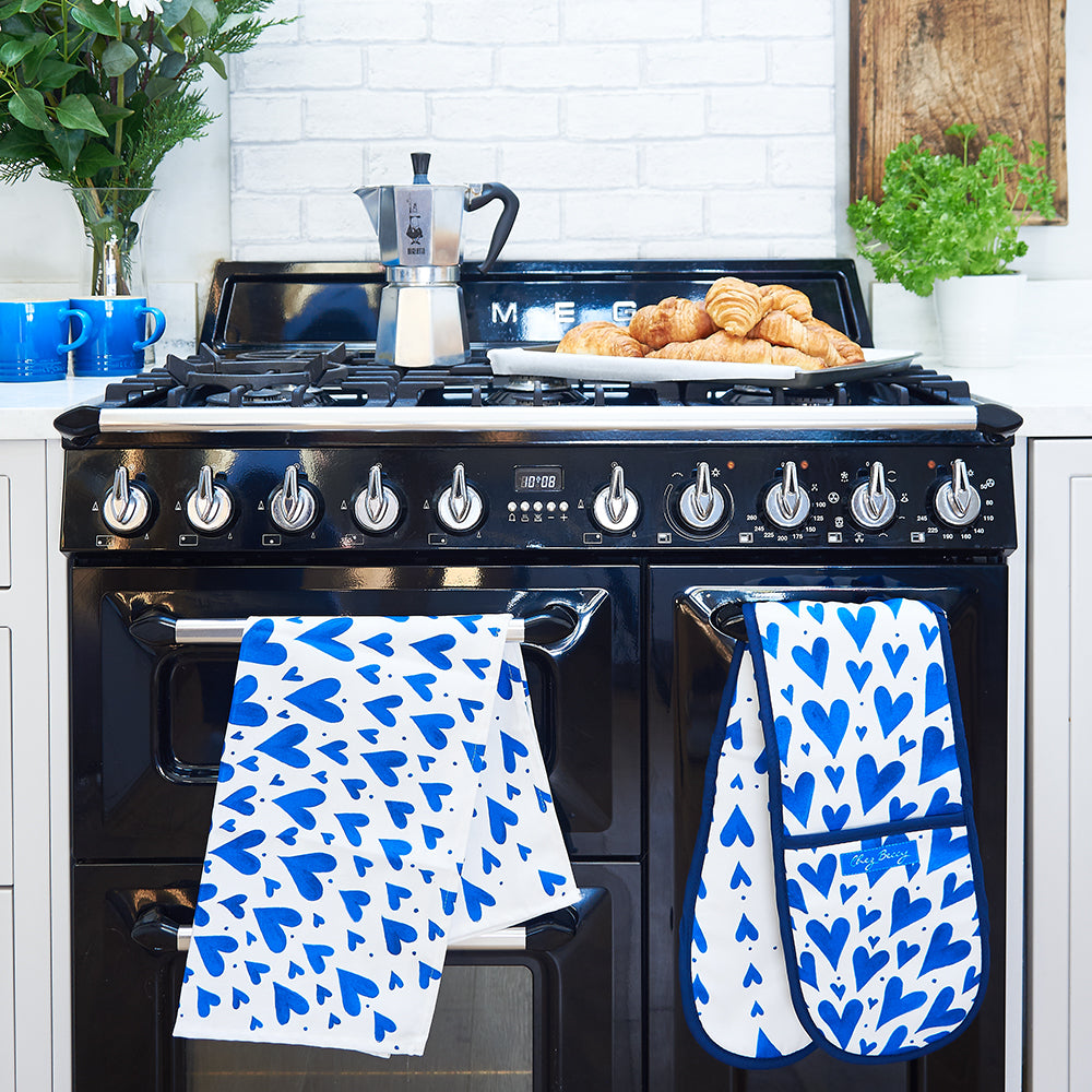 CBLue hearts tea towel and double oven glove hanging over a range cooker