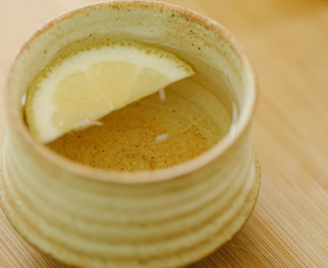 A mug with a slice of lemon in it