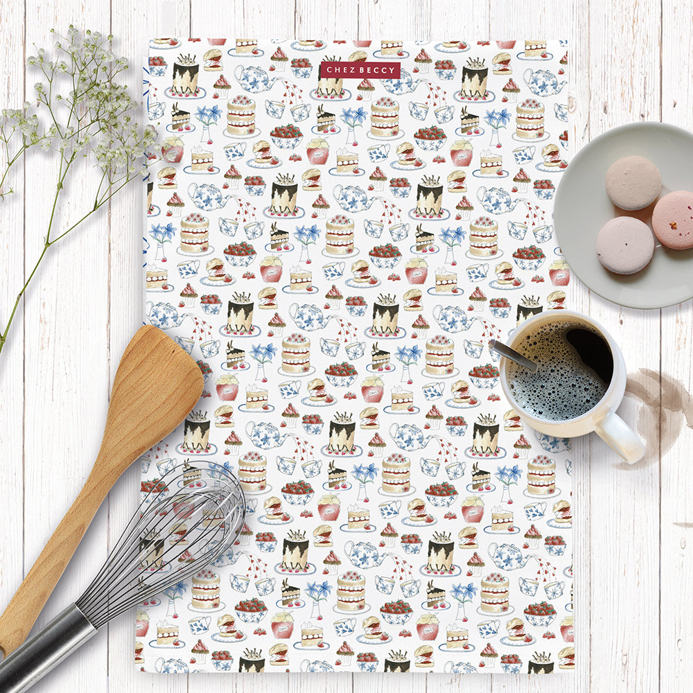 Illustrated tea towel with afternoon tea icons on a white background with baking items