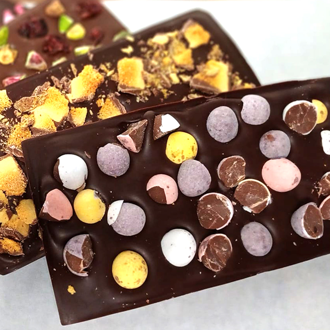 Easter Bean to Bar chocolate workshop with decorated chocolate bars topped with Easter eggs and other toppings