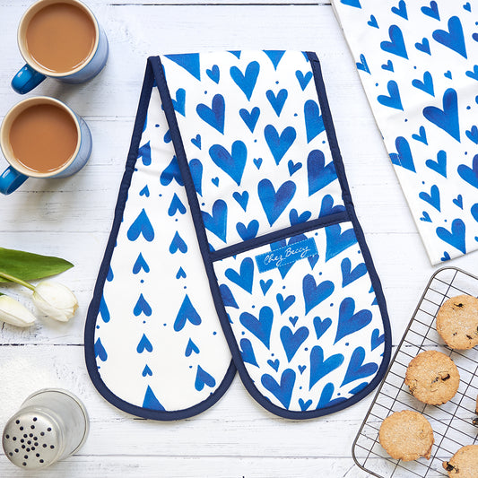 Blue hearts double oven glove and matching tea towel with 2 cups of tea and homemade biscuits