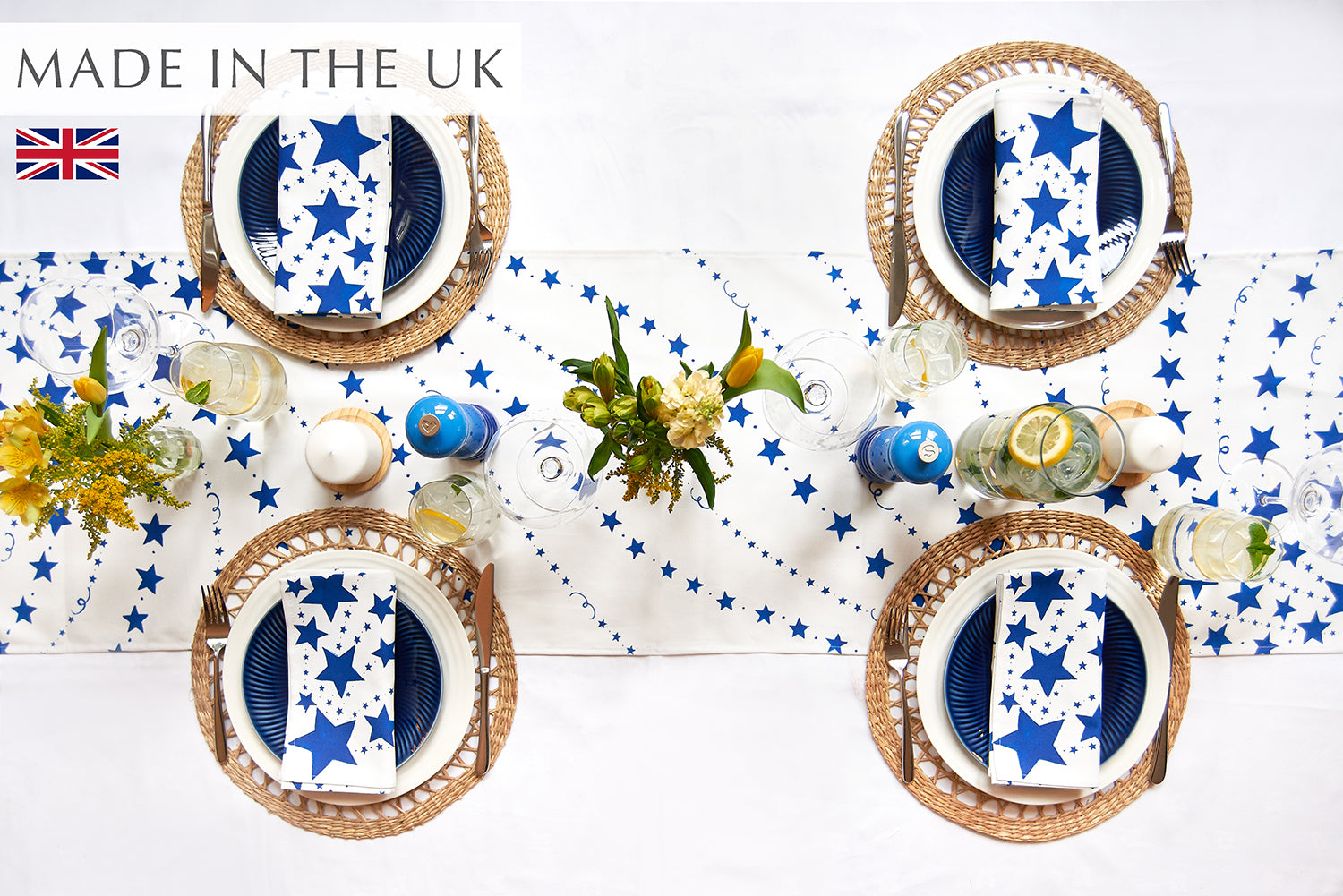 Blue stars table runner on a white cloth with 4 place settings