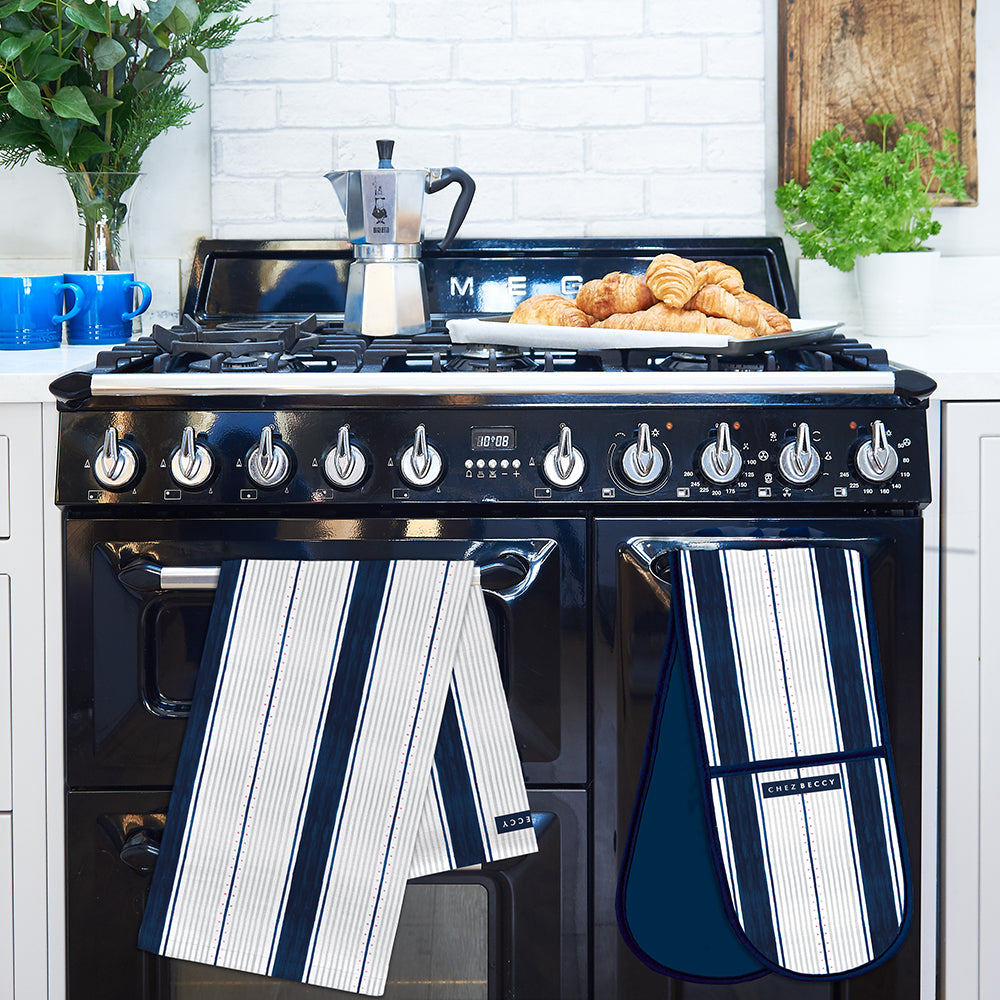 Navy and white stripe double oven glove and matching tea towel on a range cooker