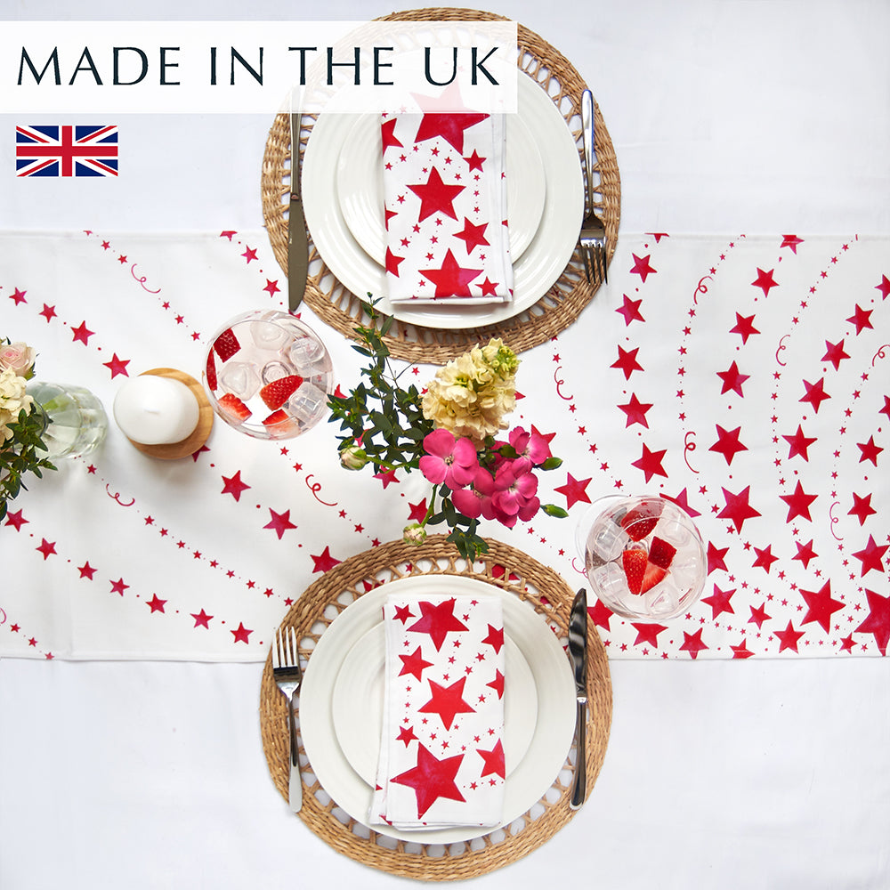 Red stars Table runner on a white cloth with 2 place settings