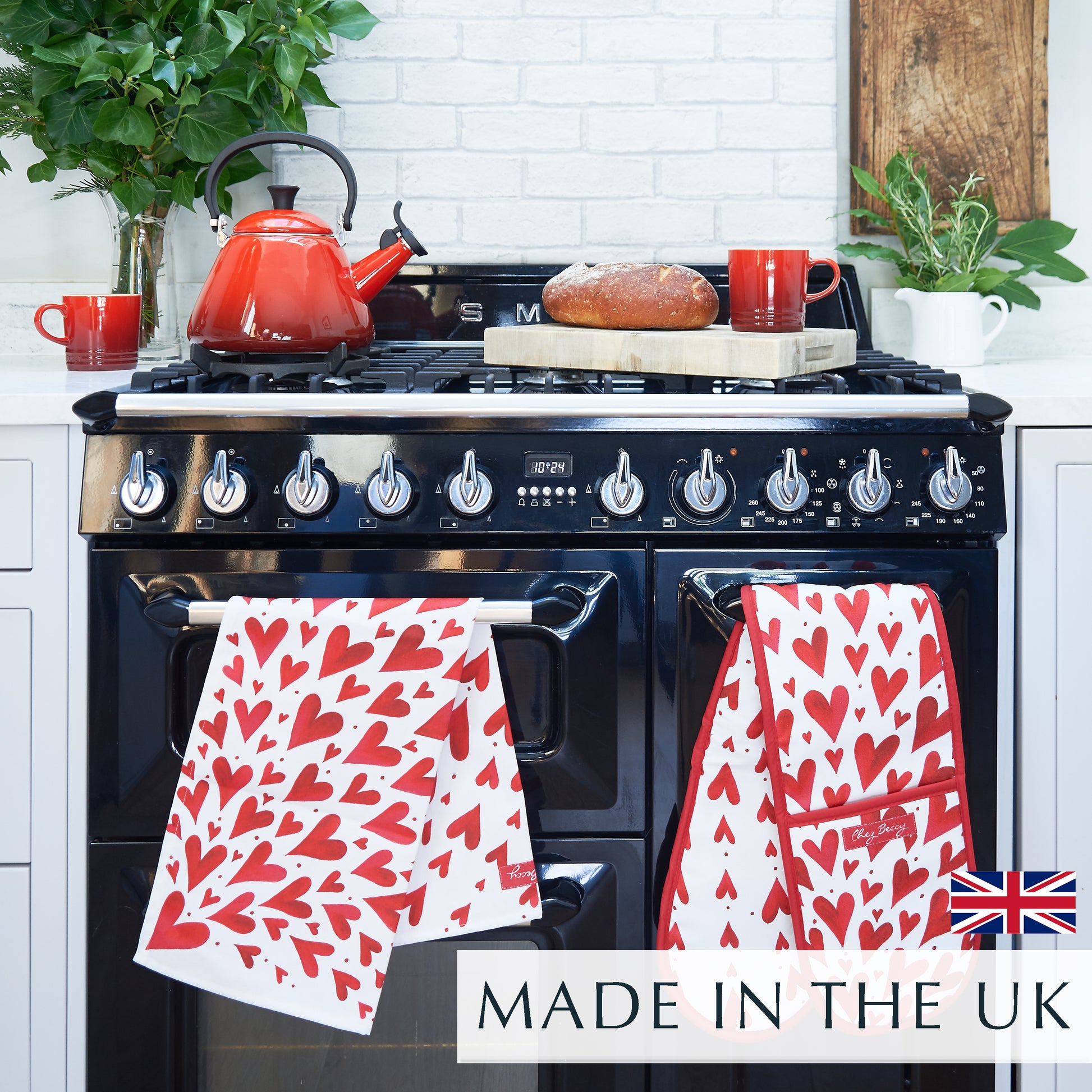 Red heart tea towel and double oven glove on a range cooker