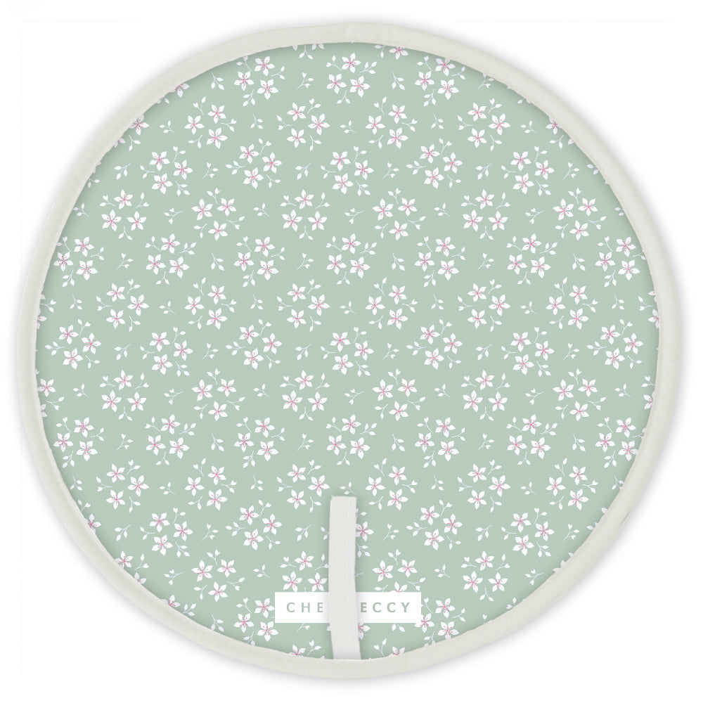 Green ditsy floral Aga circular hob cover with cream piping, 38cm diameter, made from cotton