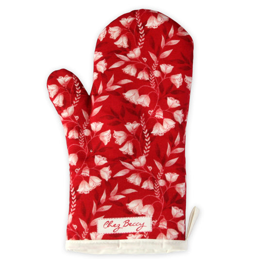 Red oven mitt with white floral pattern