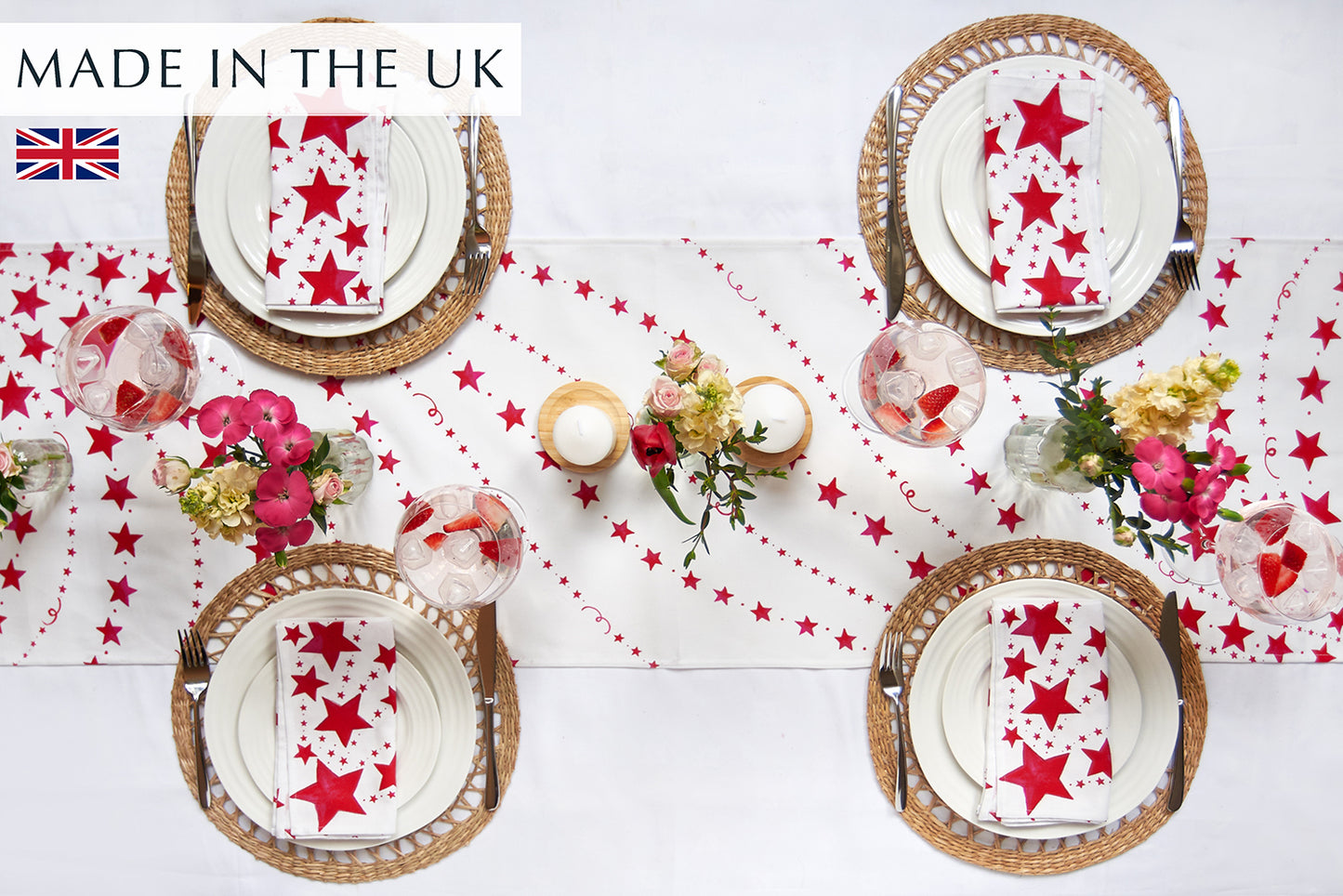 Red Stars table runner on a white cloth with 4 place settings