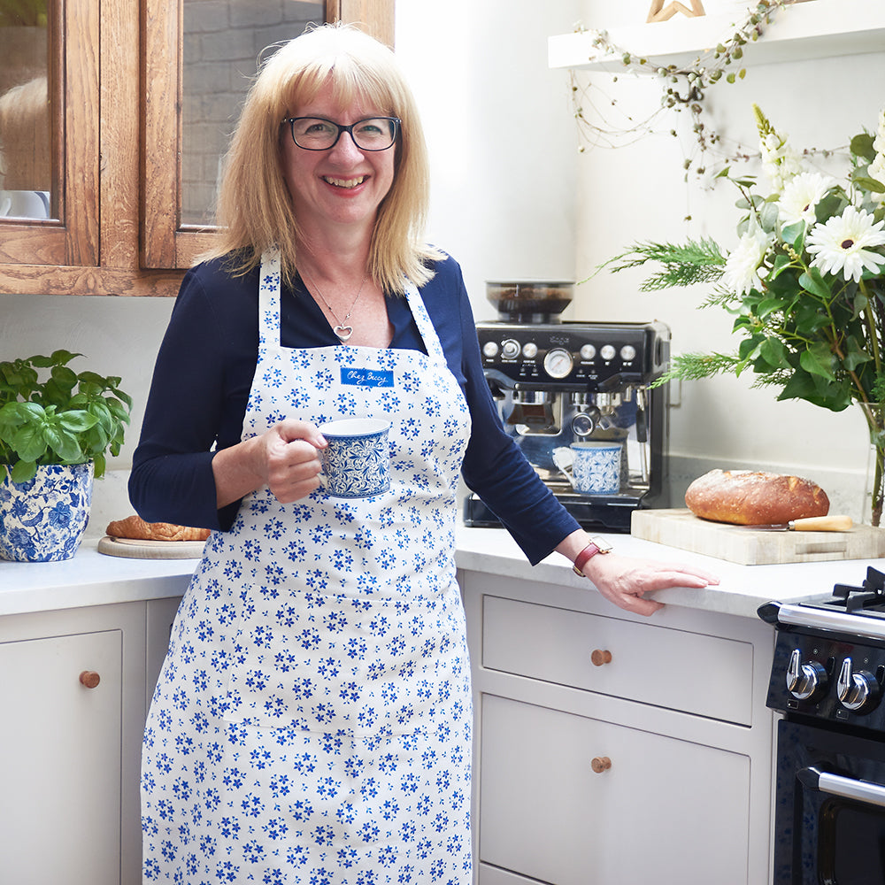 Cook Beccy in her kitchen holding a cup of tea