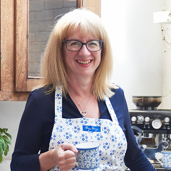 Cook Beccy in her kitchen holding a cup of tea